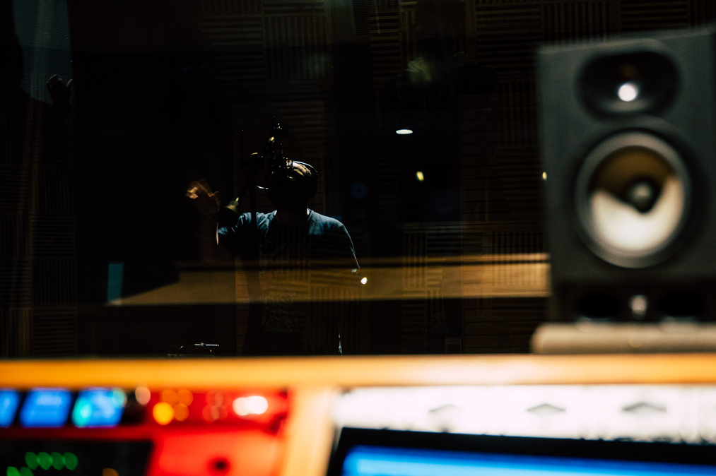 Unrecognizable vocal artist singing in recording studio